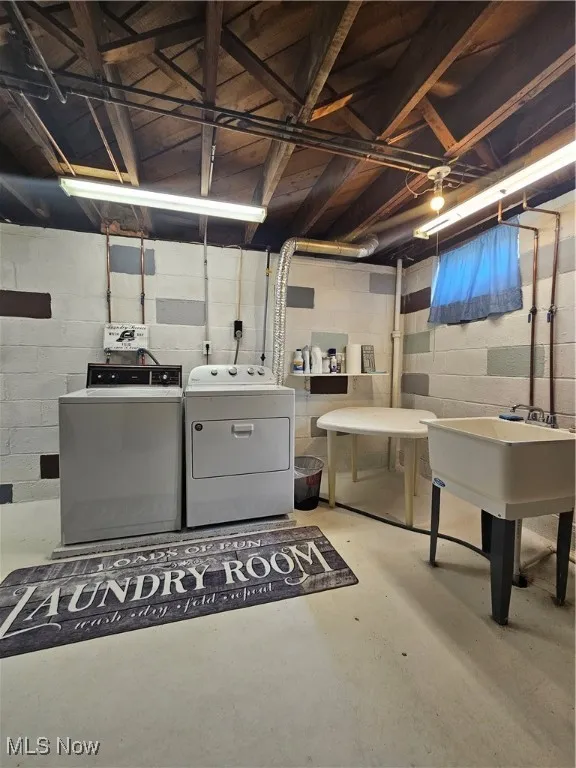 Unfinished basement featuring washer and dryer