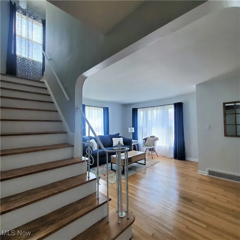 Staircase featuring wood finished floors and baseboards