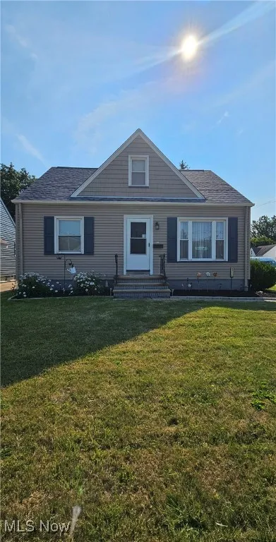 Bungalow-style home featuring entry steps and a front yard
