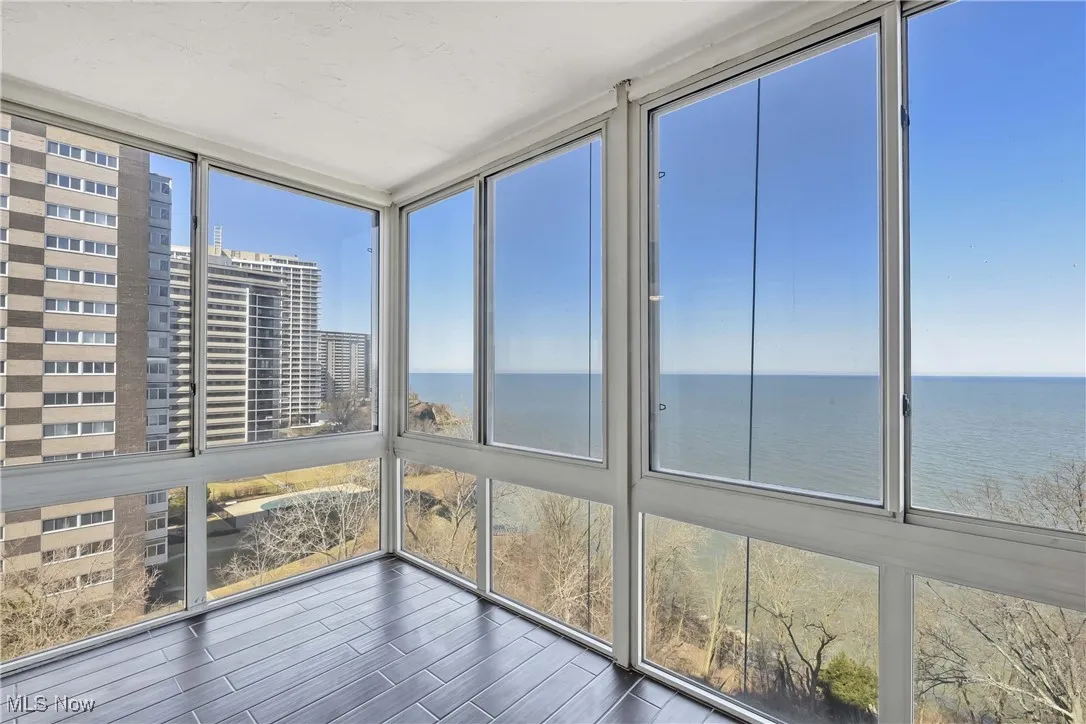 Unfurnished sunroom with a wealth of natural light and a water view