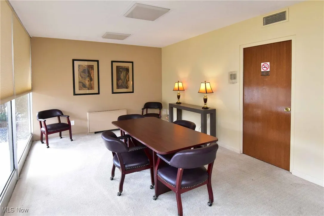 Dining space with visible vents, light colored carpet, and baseboards