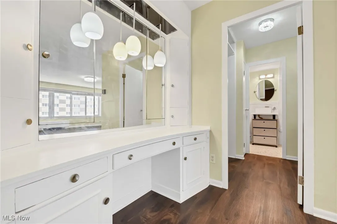 Bathroom with baseboards, wood finished floors, and vanity