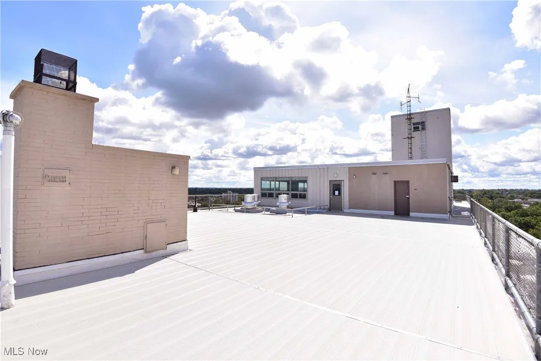 View of patio featuring fence