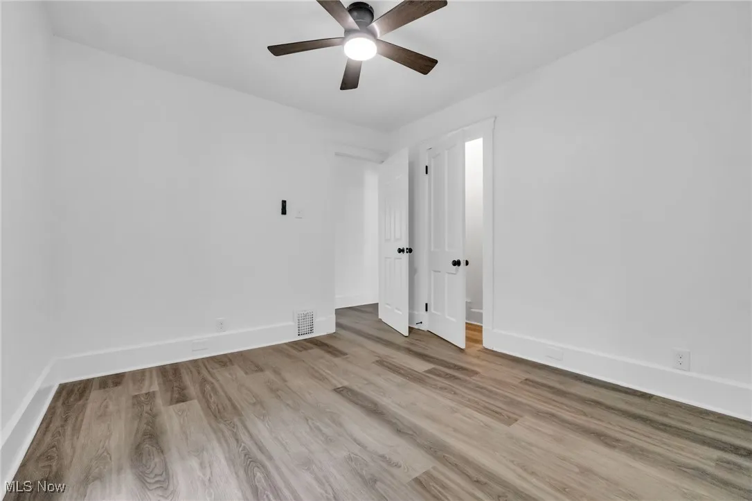 Unfurnished room featuring a ceiling fan and wood finished floors