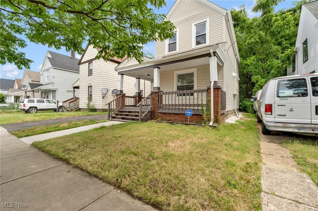 View of front of home featuring covered porch and a front yard