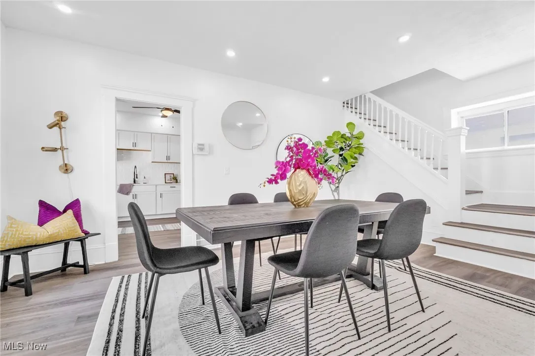 Dining area featuring light wood-style floors, stairway, and recessed lighting