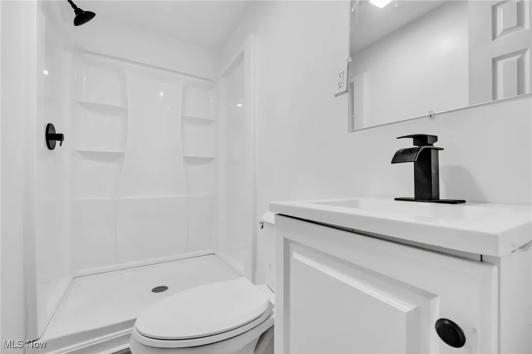 Bathroom with vanity and a shower