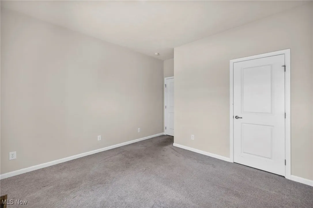 Unfurnished bedroom with carpet flooring