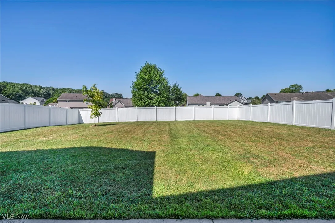 Fenced backyard with a residential view