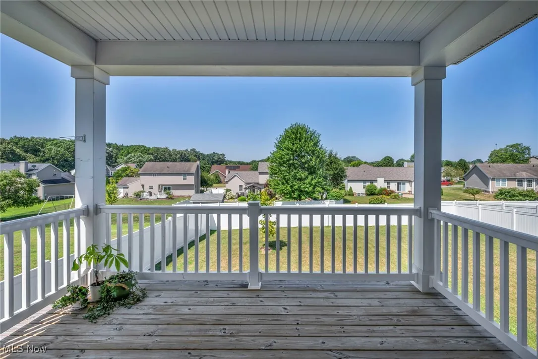 Deck with a residential view and a fenced backyard