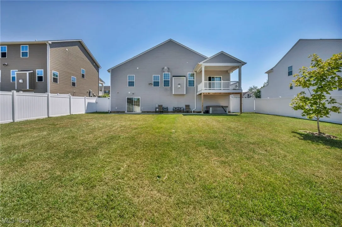Back of property with a fenced backyard