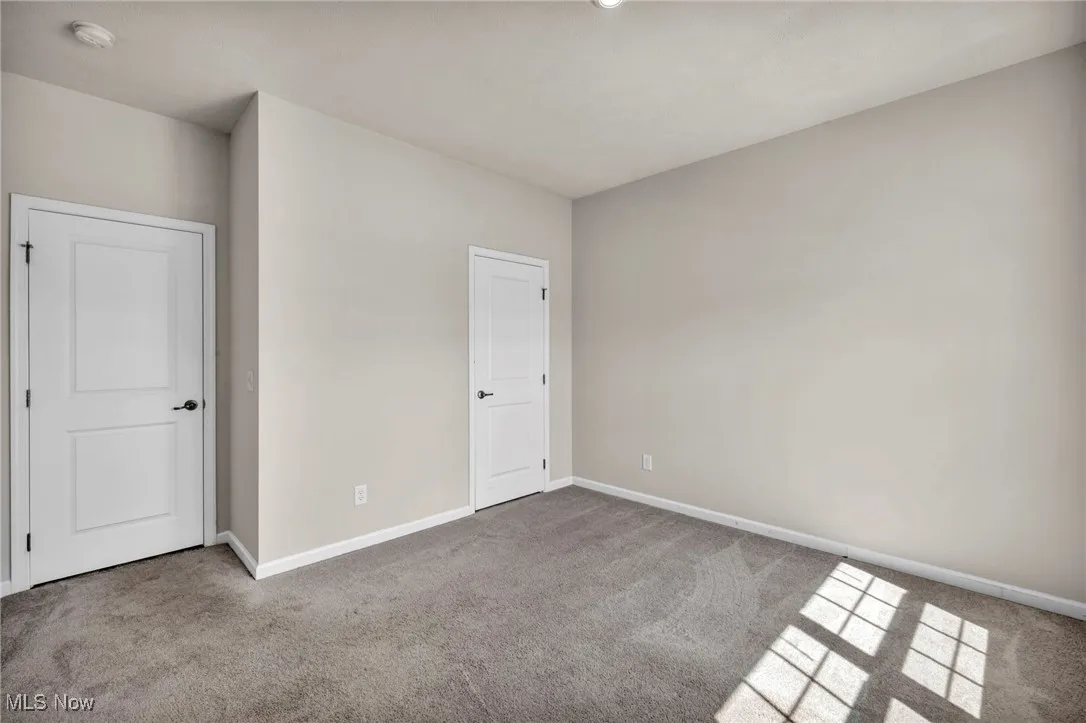 Unfurnished bedroom with carpet and baseboards