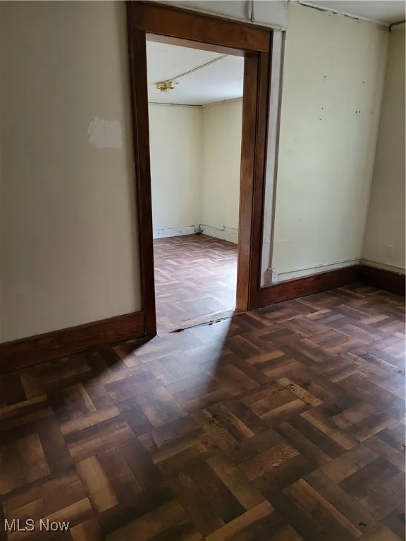 Empty room featuring baseboards
