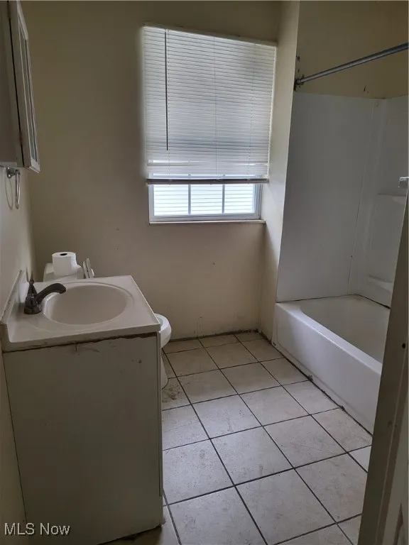 Full bathroom featuring tile patterned floors, vanity, and bathtub / shower combination