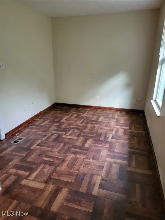 Unfurnished room featuring baseboards