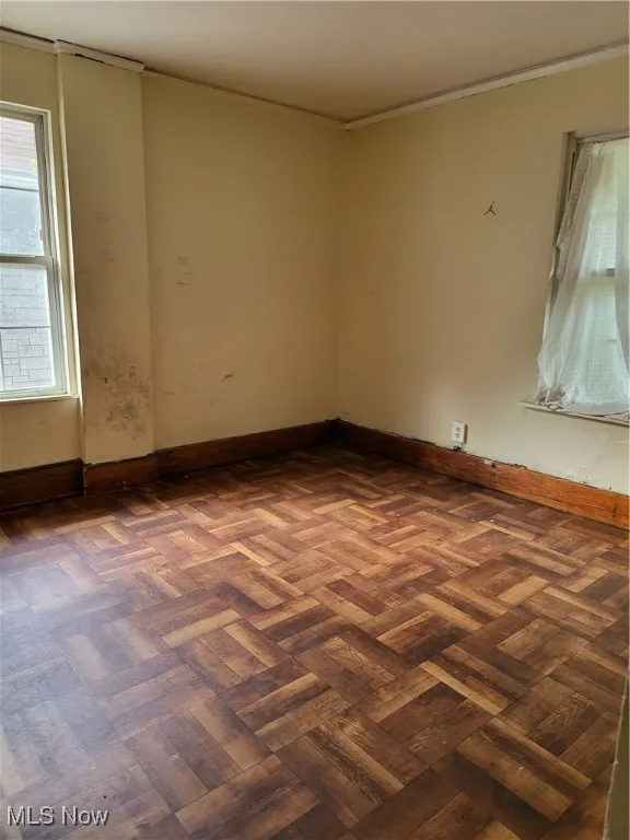 Spare room featuring baseboards