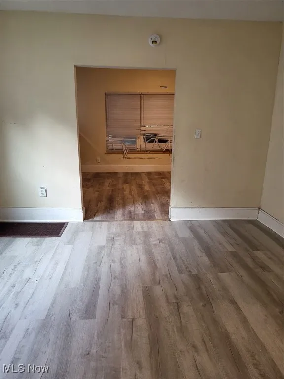 Spare room featuring wood finished floors
