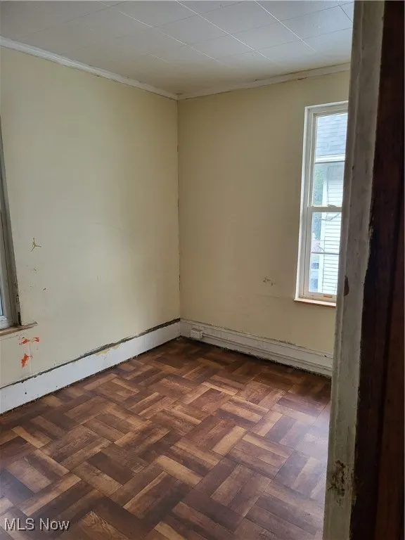 Spare room featuring crown molding