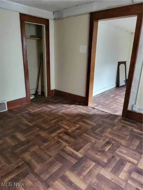 Unfurnished bedroom with baseboards and a closet
