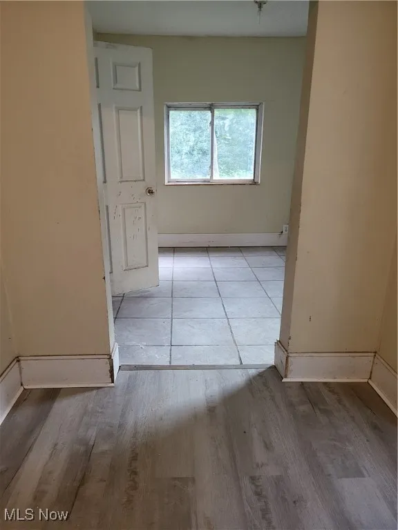 Hallway featuring baseboards and wood finished floors