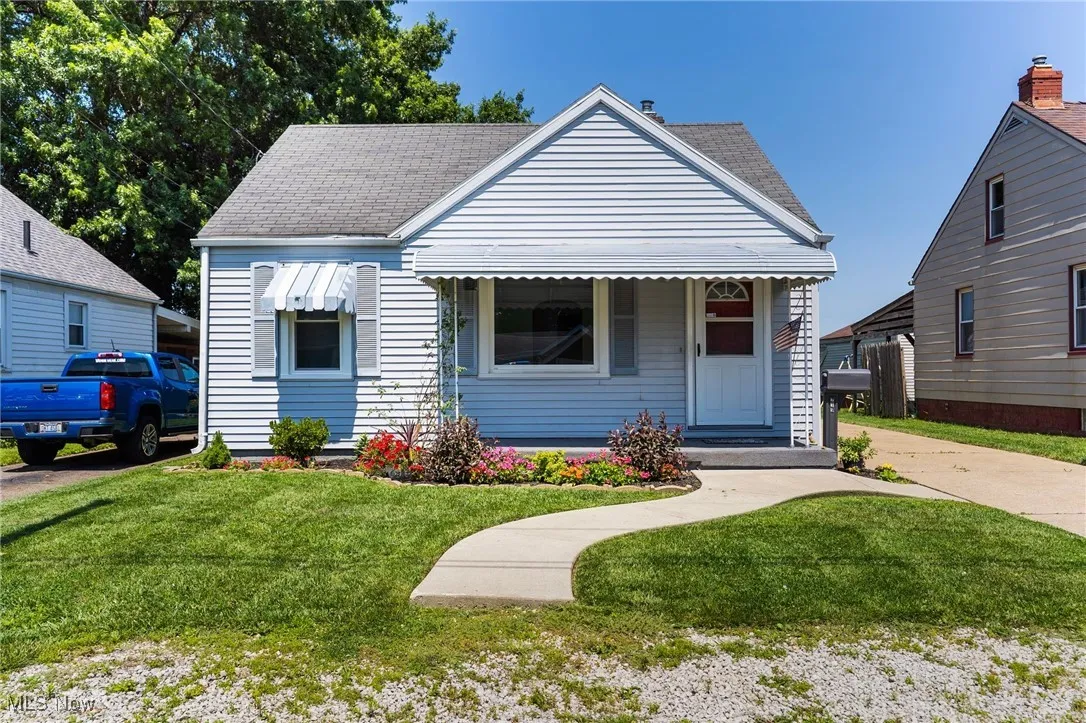 Bungalow-style house with a front yard and a shingled roof