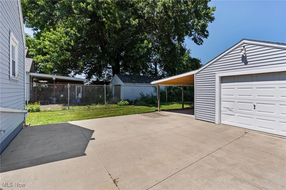 Garage featuring concrete driveway and a garage