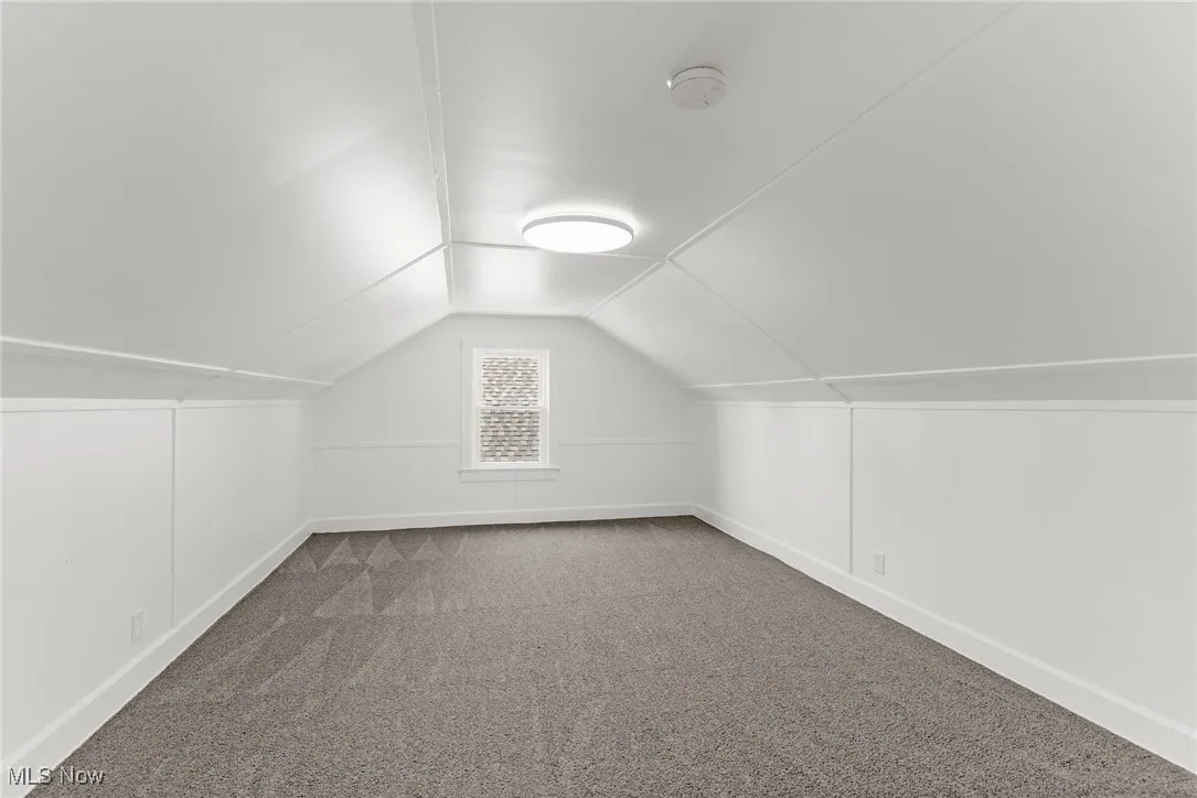Upstairs featuring carpet and lofted ceiling