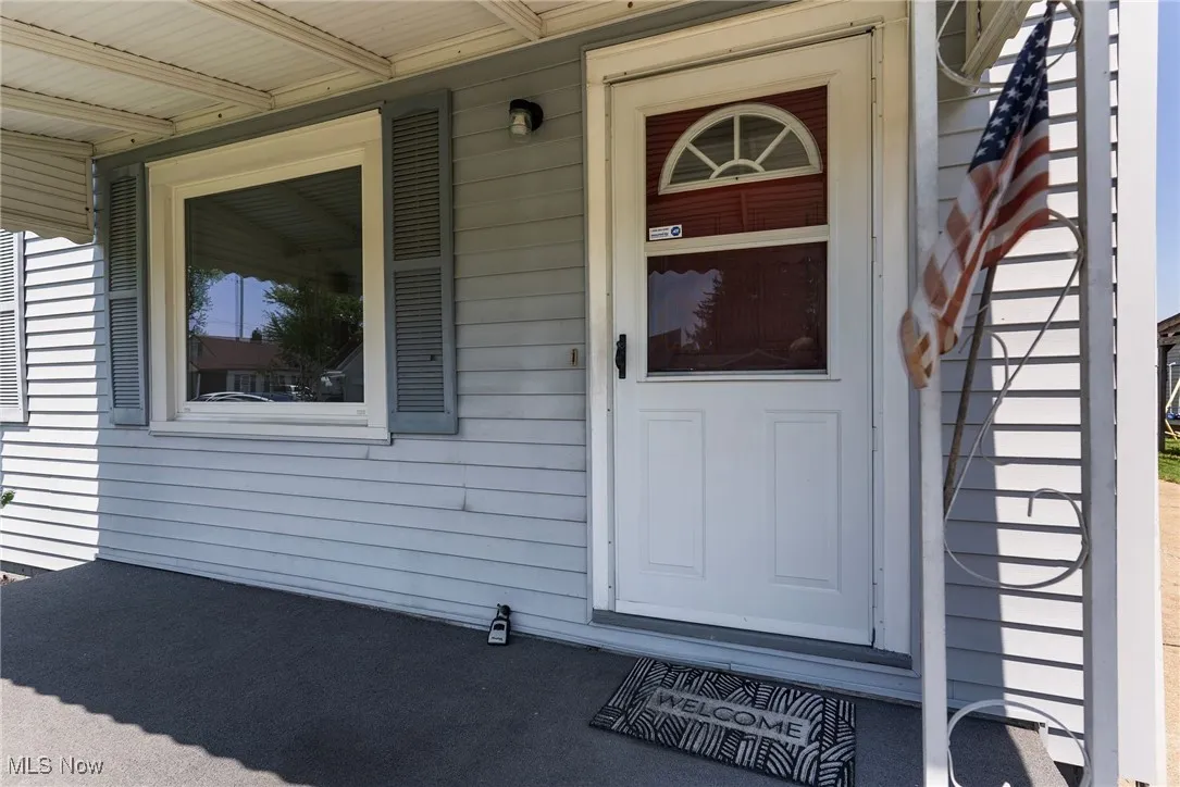 Entrance to property featuring covered porch