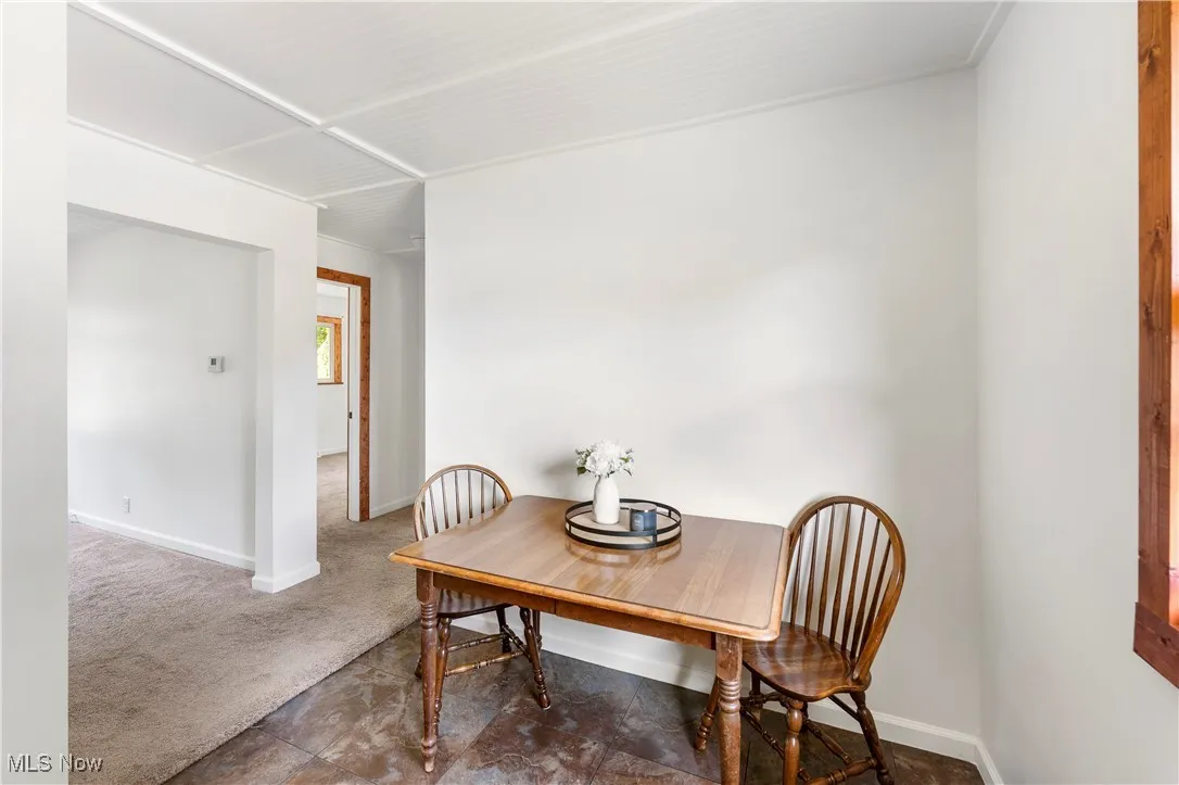 Dining room featuring baseboards and carpet