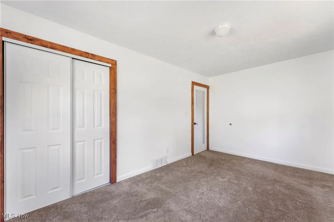 Unfurnished bedroom featuring carpet floors and a closet