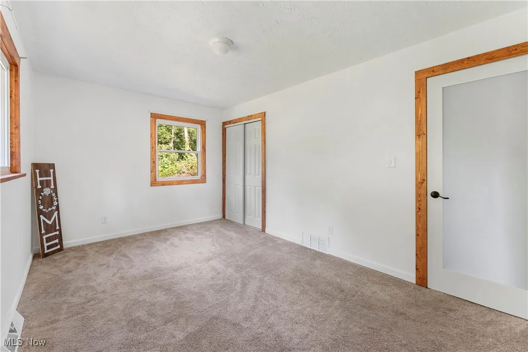 Unfurnished bedroom featuring carpet floors and a closet