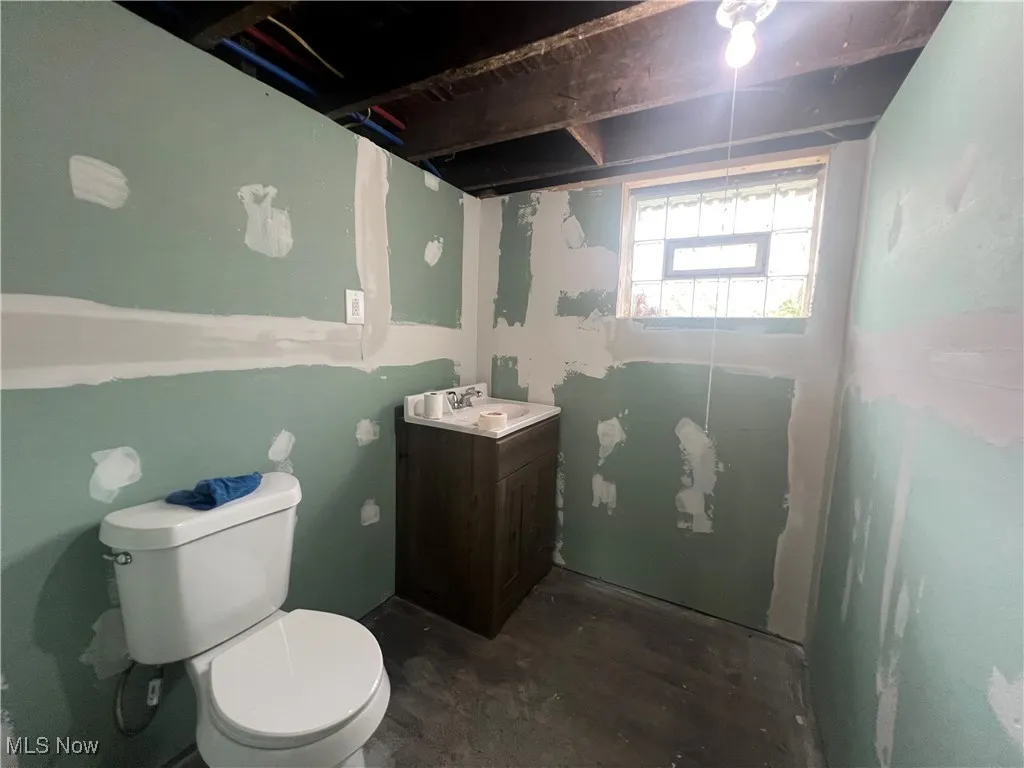 Basement bathroom with toilet and vanity