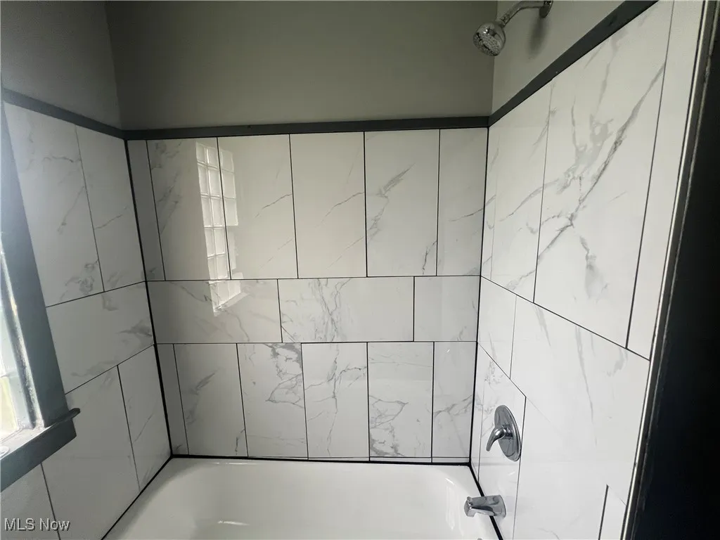 Full bath with shower / tub combination and plenty of natural light