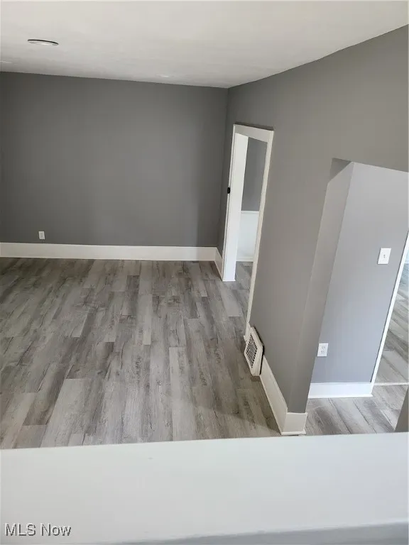 Spare room with wood finished floors and baseboards