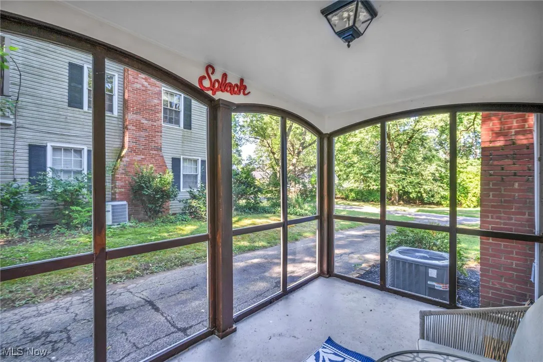Another view of attached screened-in porch showing side driveway.
