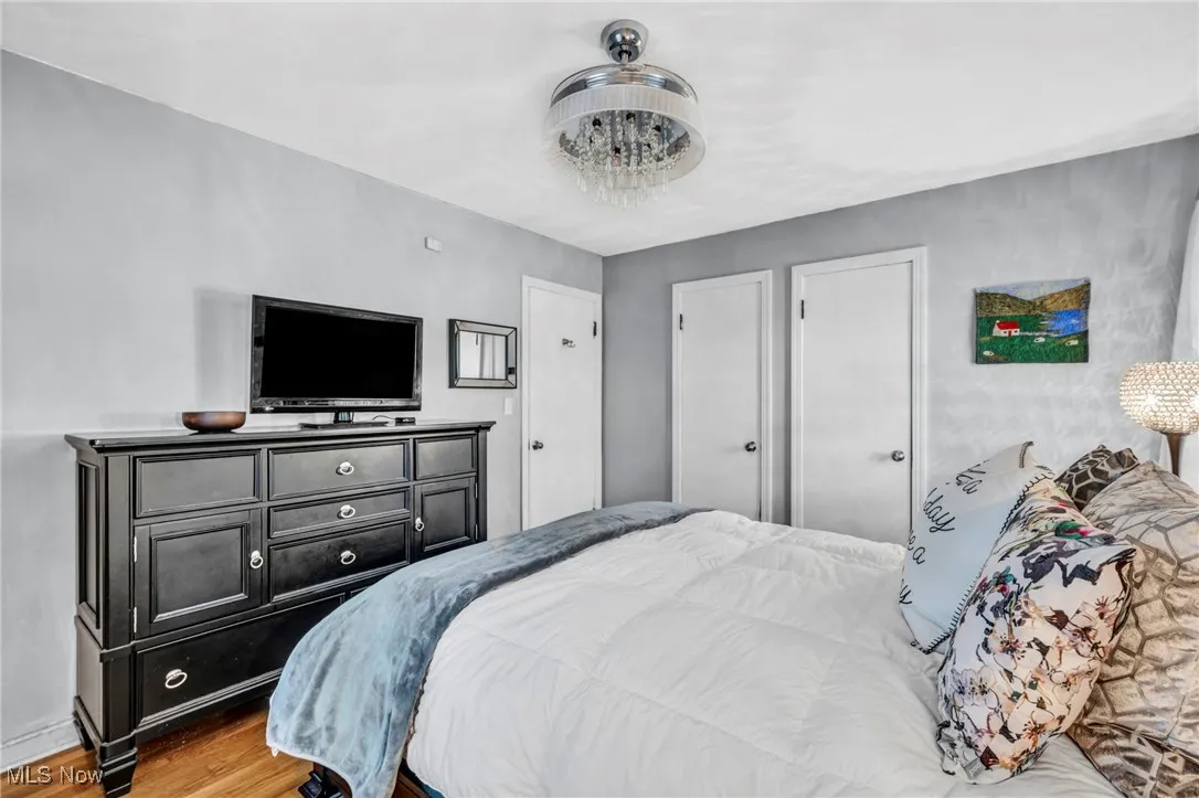 First floor bedroom with original hardwood floors, crystal fandelier and 2 closets for ample storage.