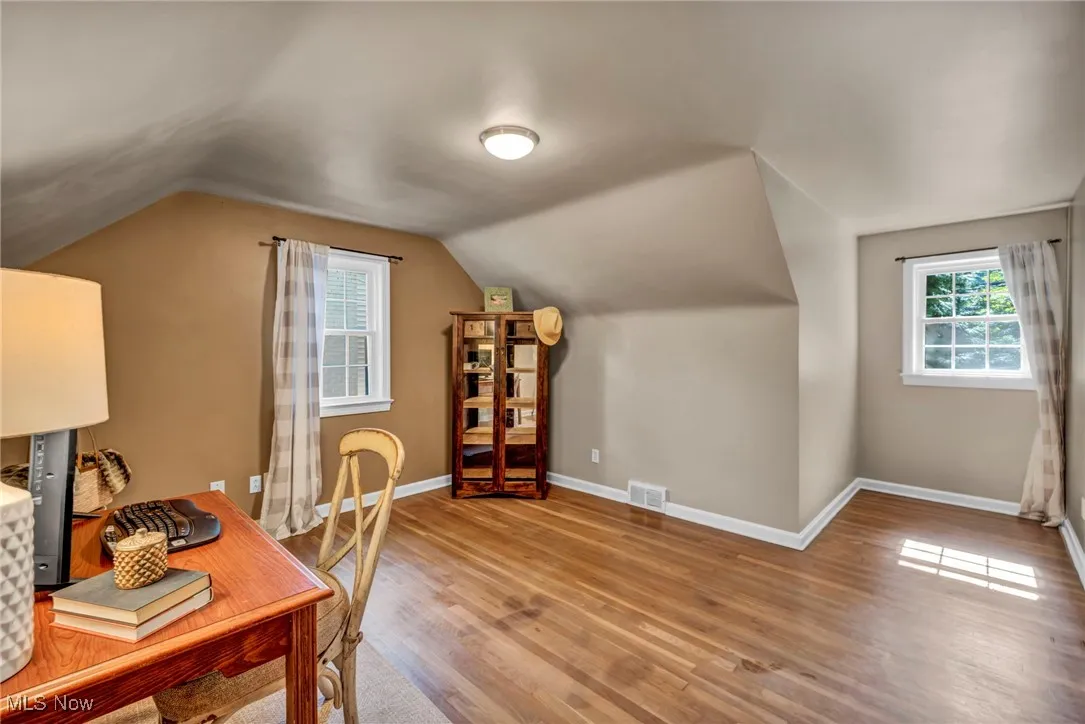 Second floor office space or bedroom with original hardwood and lofted ceiling.