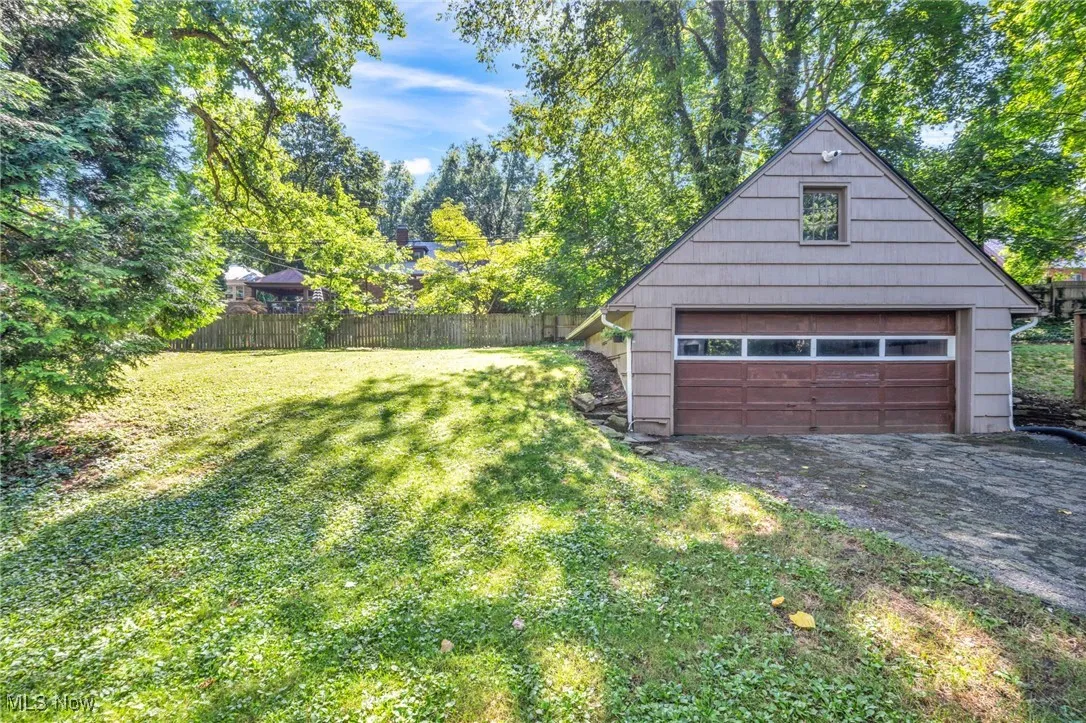 Two car detached garage behind home.