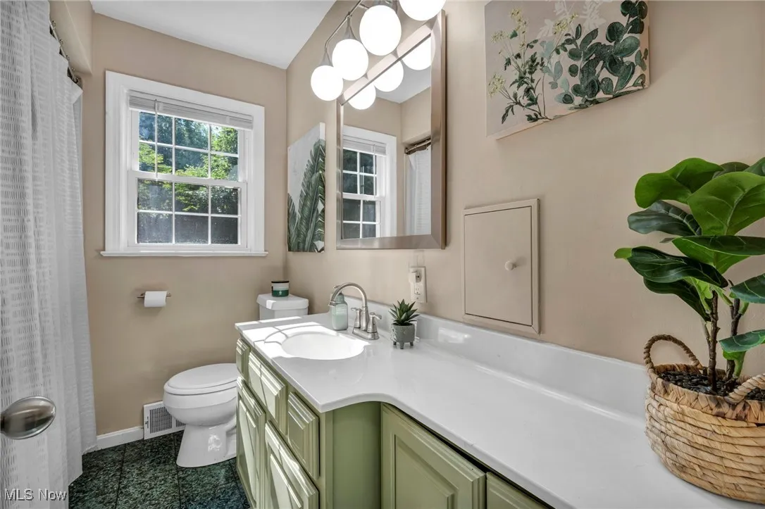 First floor full bathroom featuring extra long vanity, new lighting and mirror with soaker tub for relaxing.