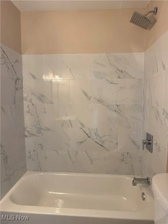 Bathroom with toilet and bathtub / shower combination