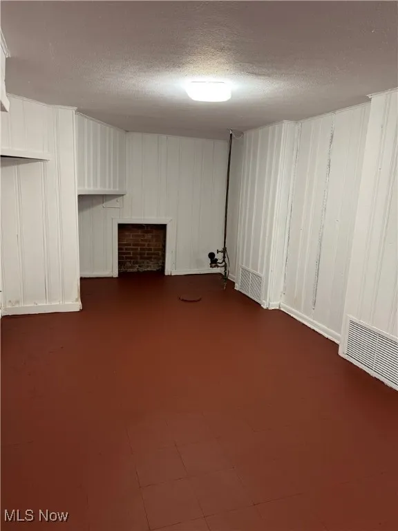 Finished basement featuring a textured ceiling