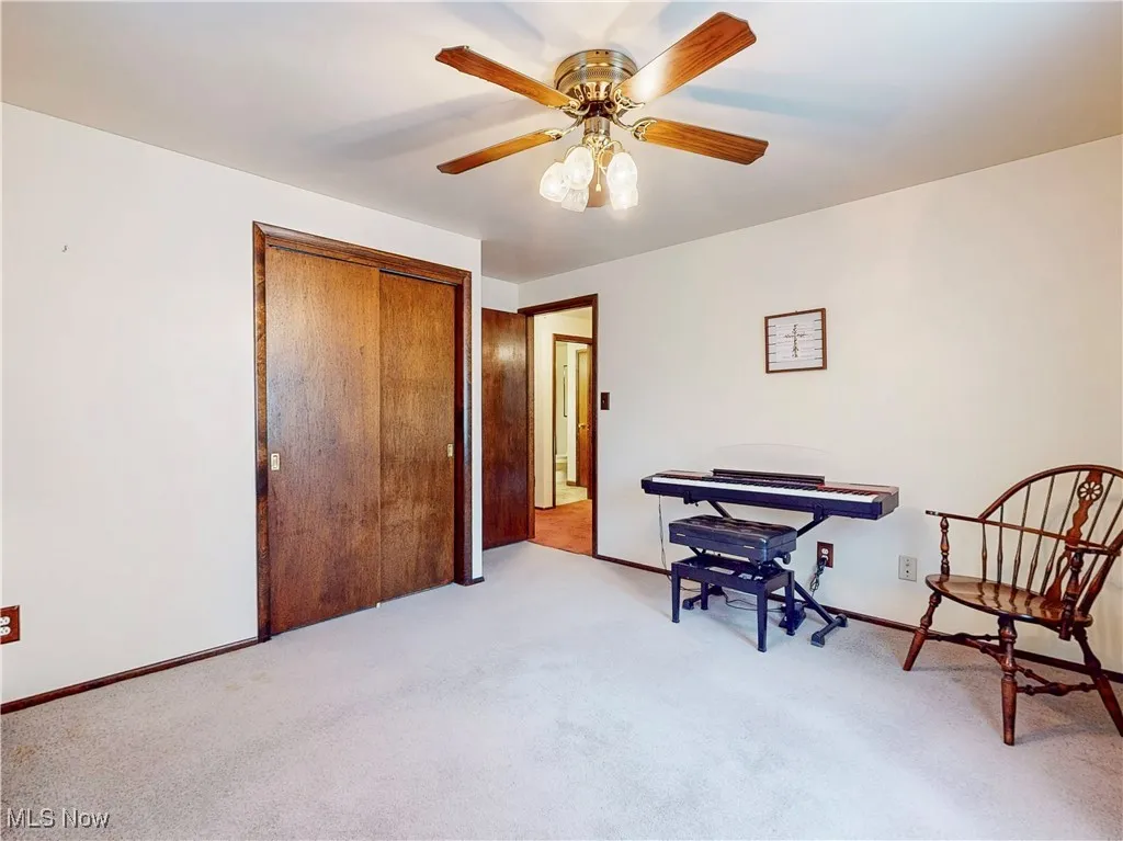 Sitting room with carpet floors and a ceiling fan