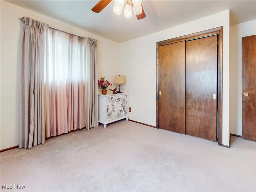 Unfurnished bedroom with carpet flooring, a closet, and ceiling fan