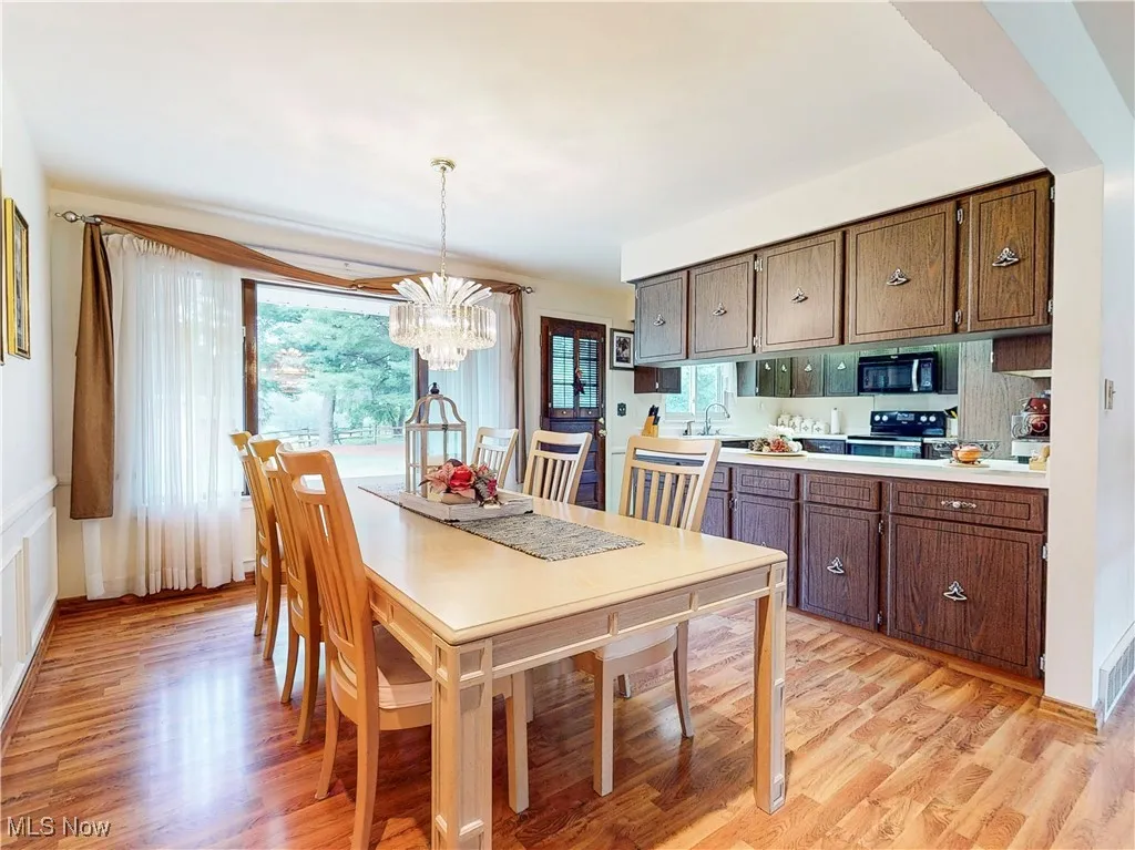 Dining space featuring a chandelier and light wood-type flooring