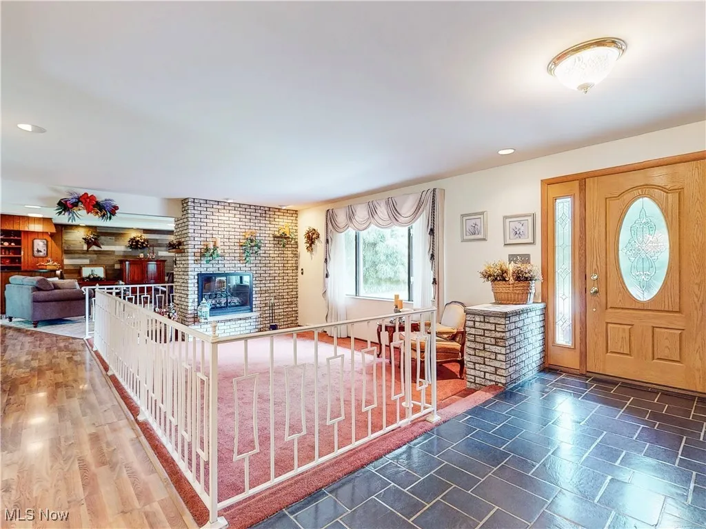 Entryway featuring recessed lighting and a brick fireplace