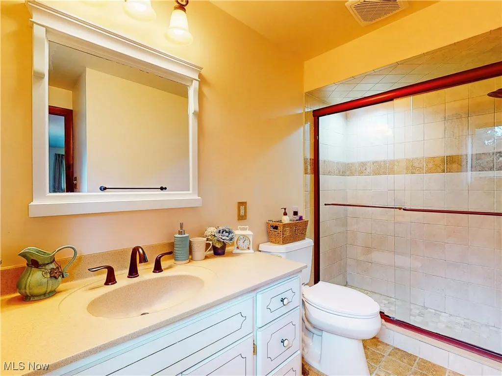 Full bathroom with a stall shower and vanity