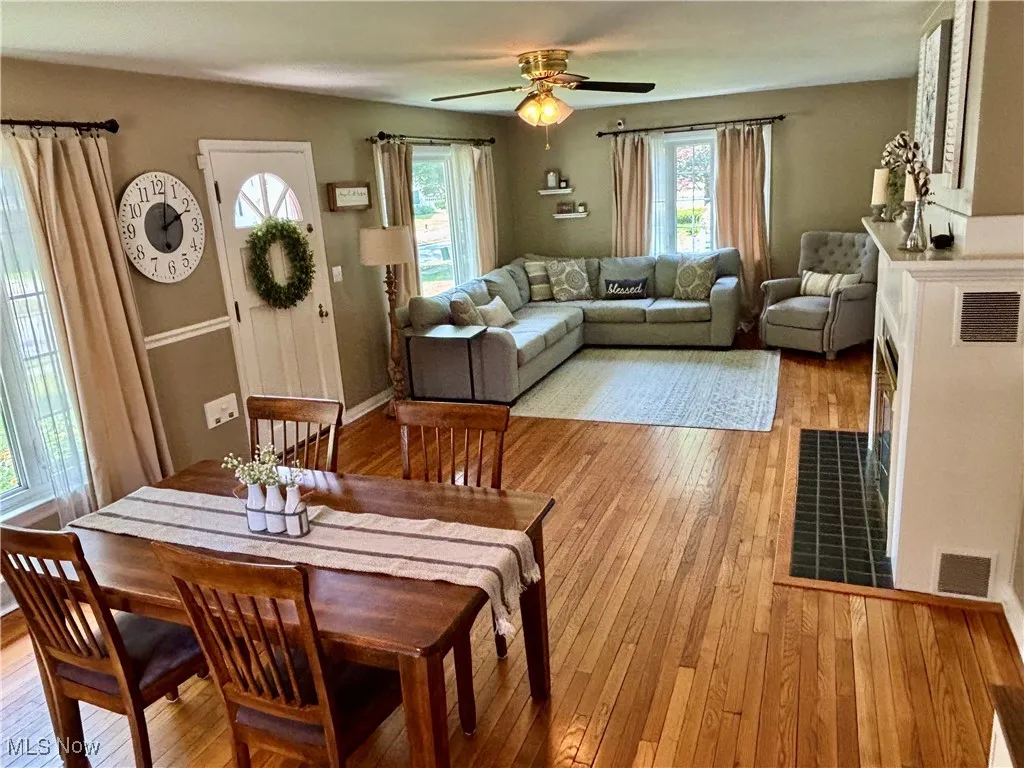 Dining room with light wood-style flooring, plenty of natural light, and a ceiling fan