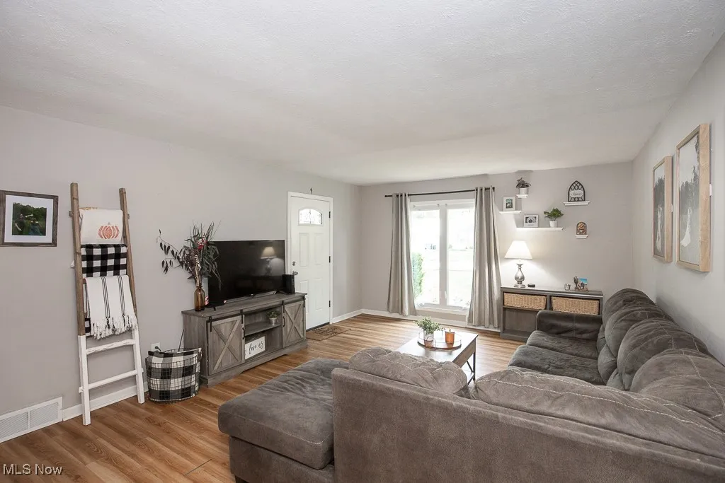 Living area with wood finished floors and baseboards