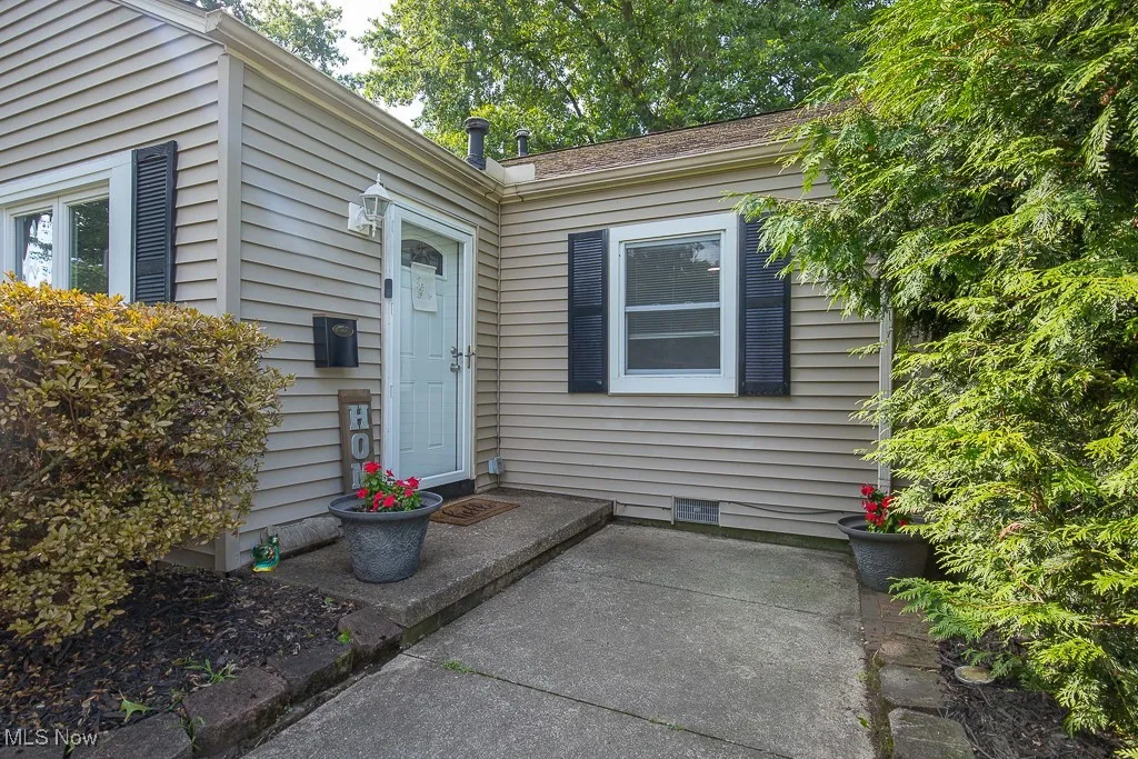 View of exterior entry with crawl space and a patio