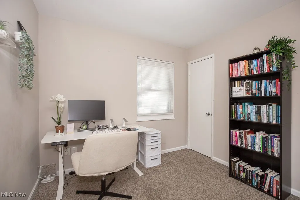 Home office with carpet floors and baseboards